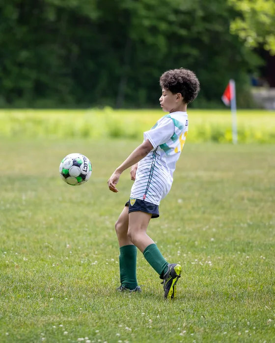 An NSYSA player volleys the ball near the corner flag during a Saturday game